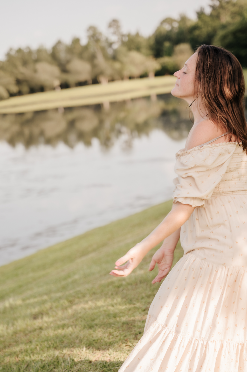 Dancer in an expressive worship pose outdoors among the trees