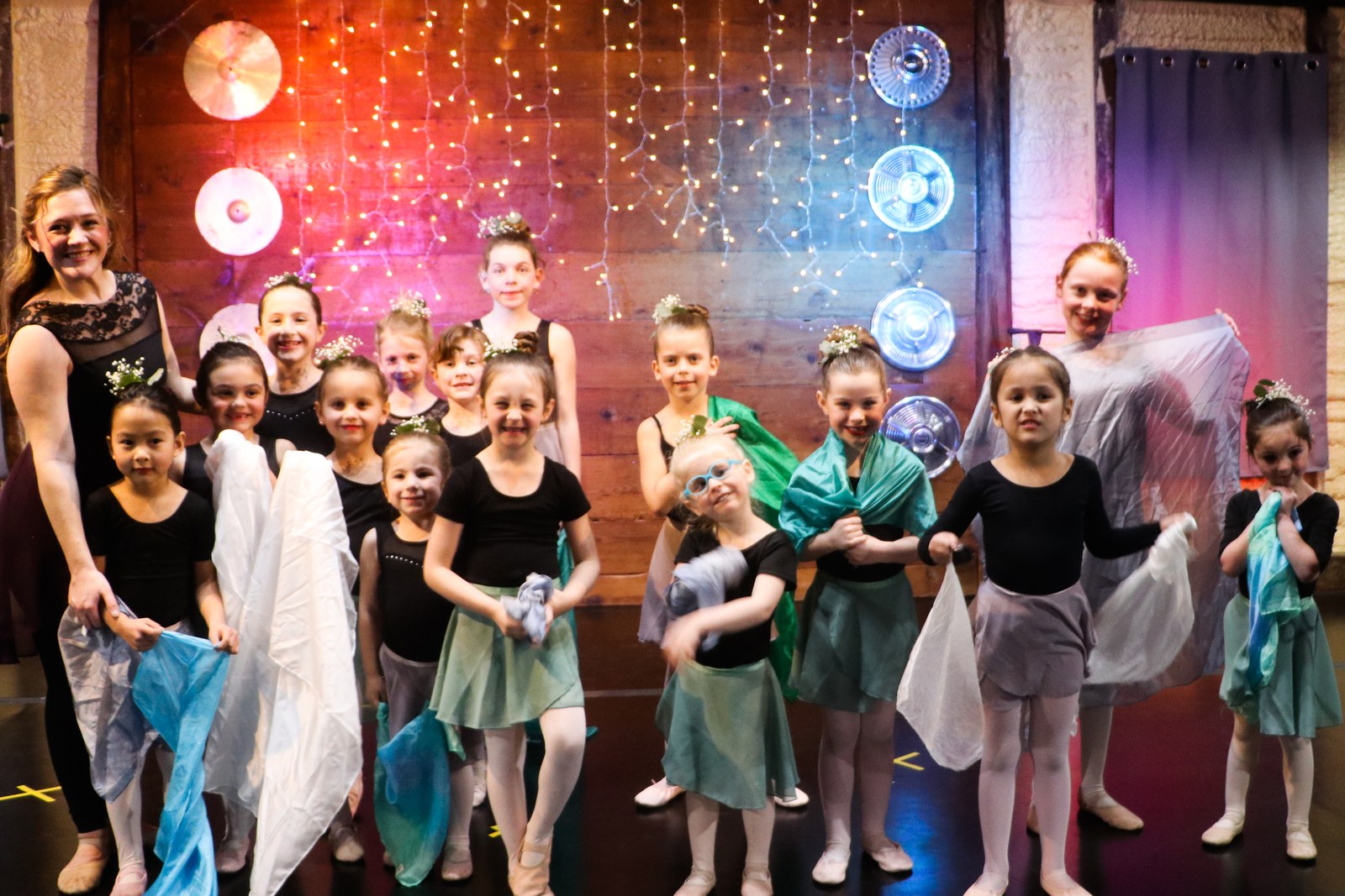 The whole class together on stage with their instructor at the recital