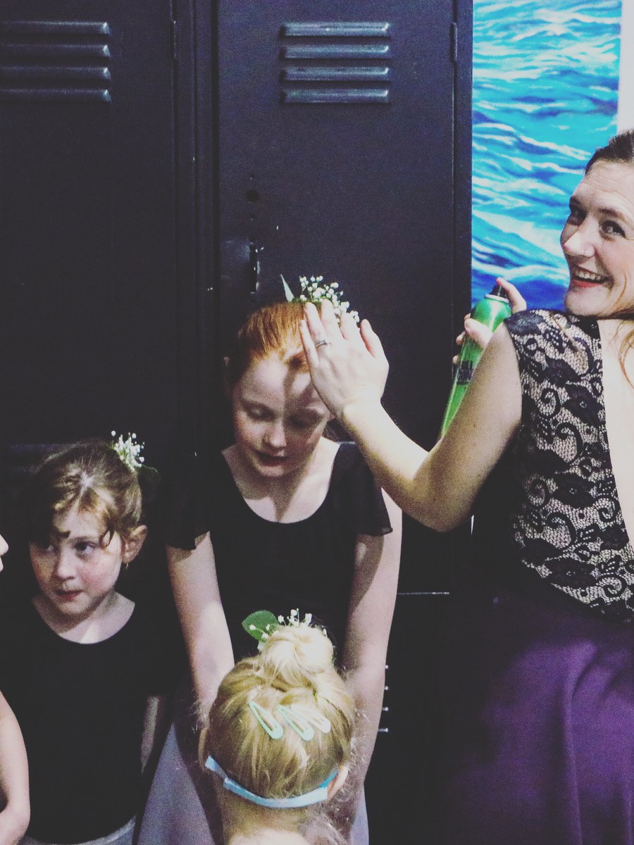 Dancers getting ready backstage before the theatrical showcase