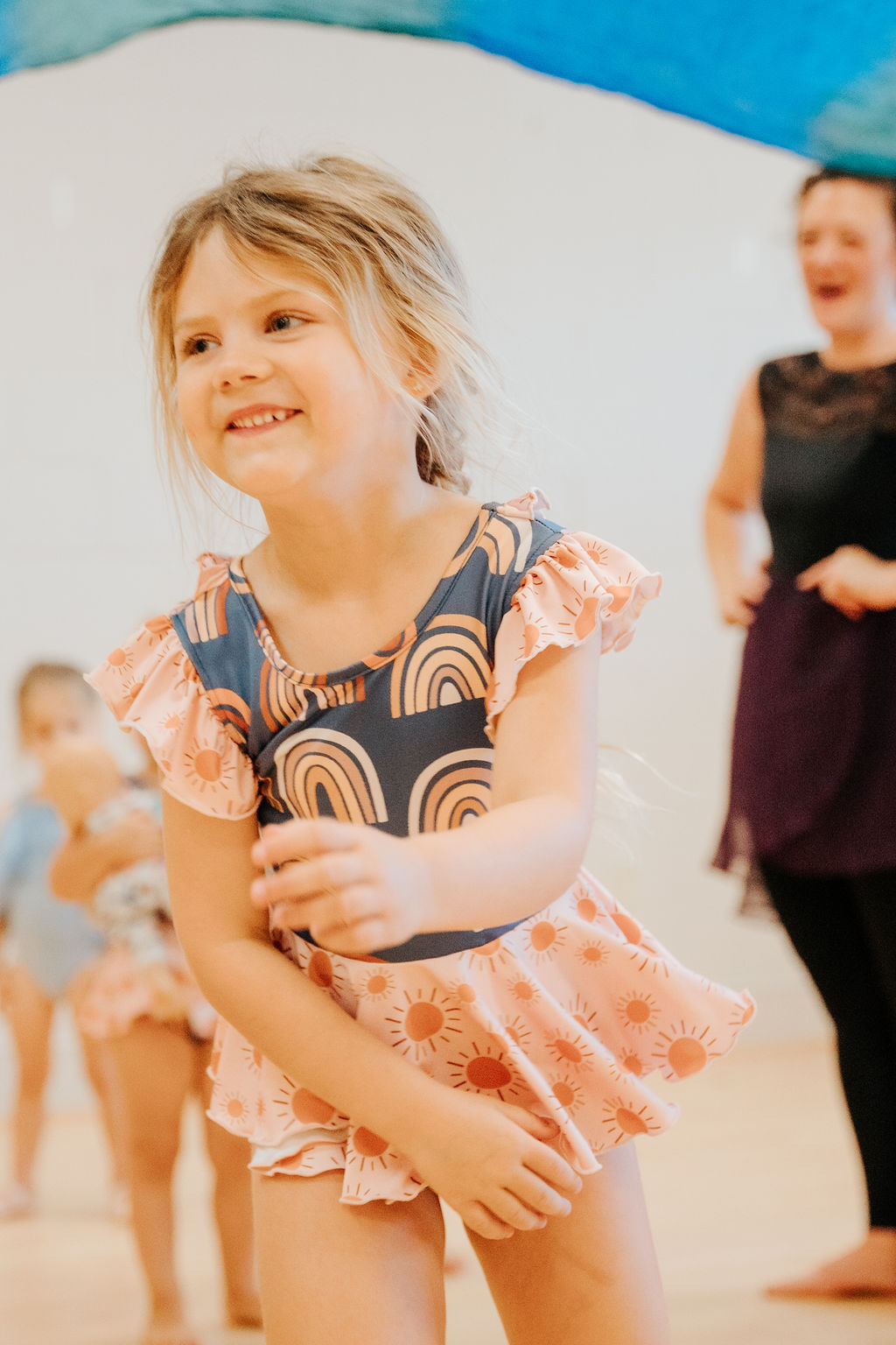 A little dancer beaming during class
