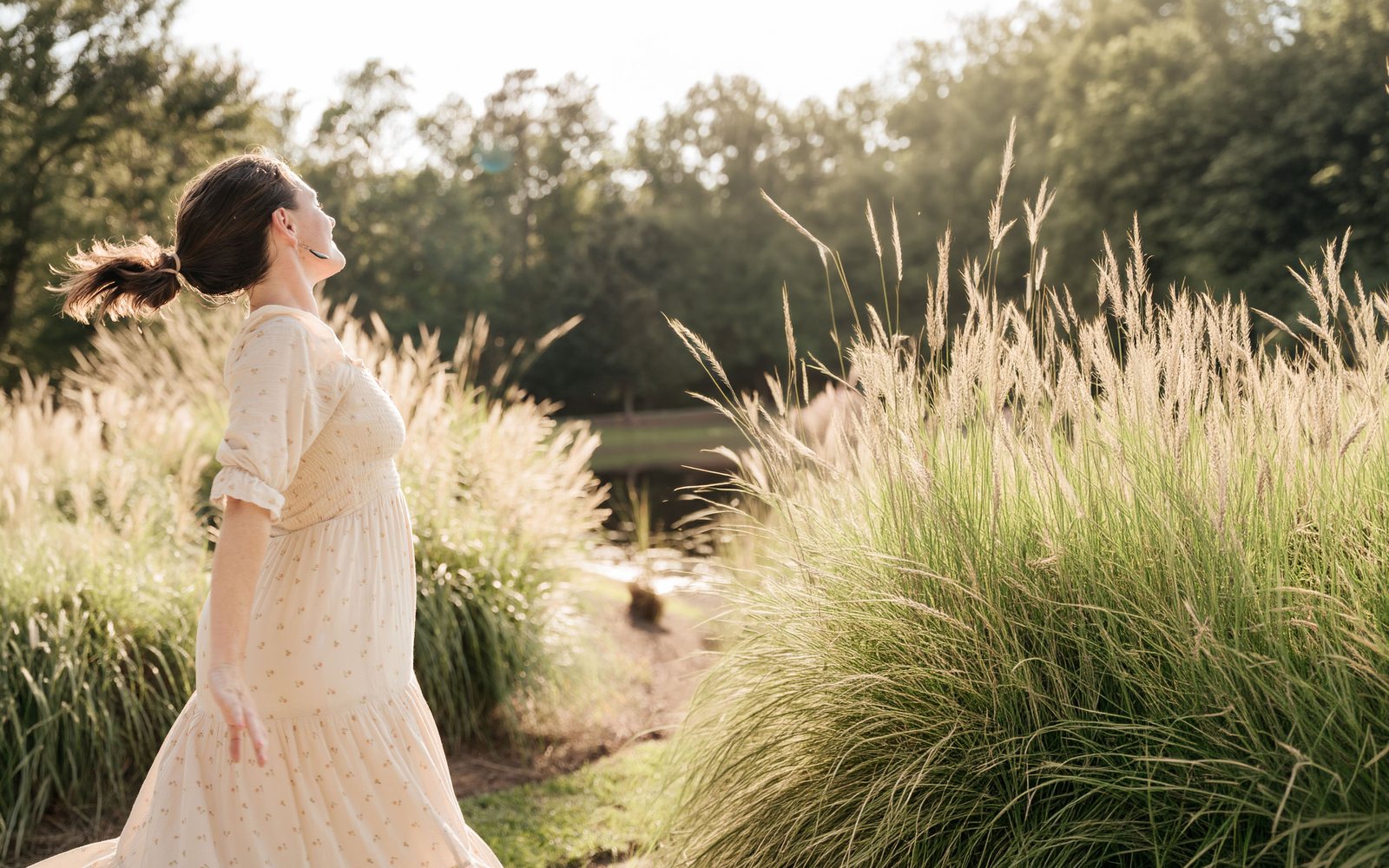 Our founder turning in a field of grasses at golden hour